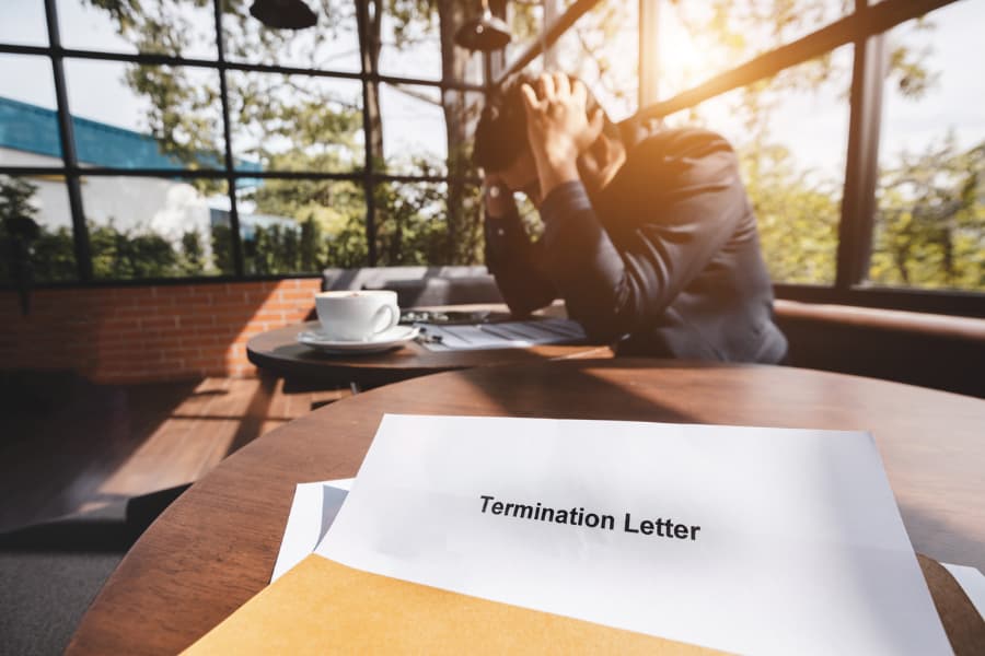 Stressed man and termination letter